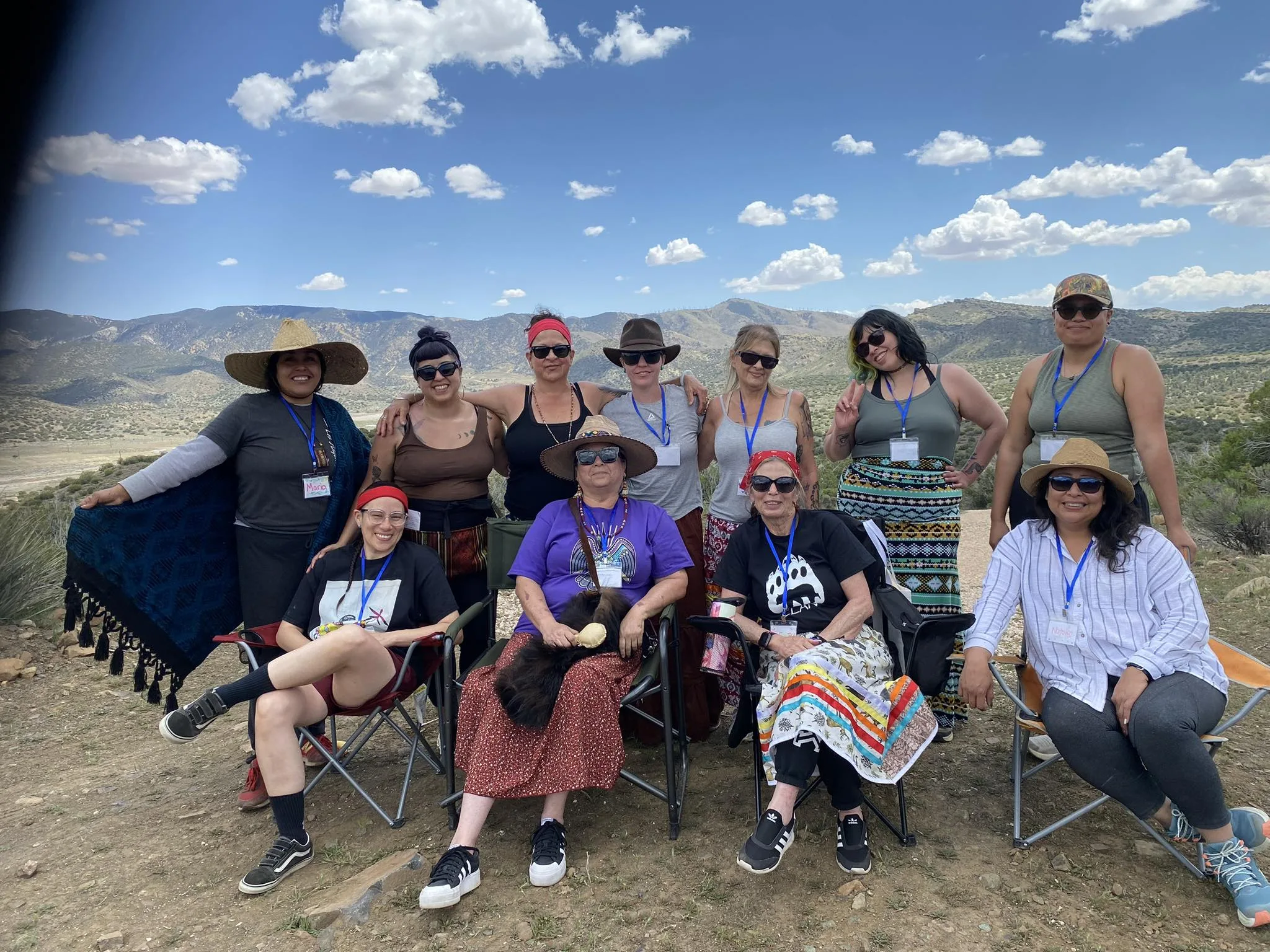 Community gathered outdoors in a retreat circle for ceremony and connection.
